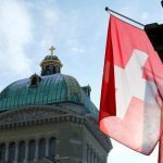A Swiss flag is pictured in front of the Federal Palace (Bundeshaus) is pictured in Bern