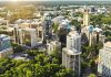 Charlotte NC skyline with modern buildings and greenery.