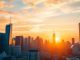 City skyline at sunset depicting financial growth.