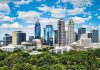 Charlotte skyline with greenery, highlighting investment opportunities.