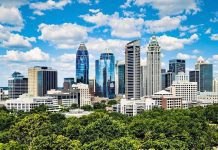 Charlotte skyline with greenery, highlighting investment opportunities.