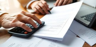 Financial professional reviewing private security documents at desk.