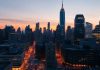 City skyline at dusk highlighting financial district buildings.