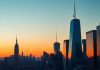 New York City skyline at sunset with iconic buildings.