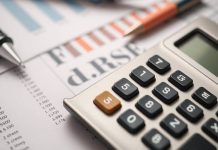 Calculator and documents illustrating financial planning objectives.