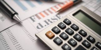 Calculator and documents illustrating financial planning objectives.