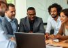 Group of investors discussing strategies around a table.