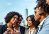 Diverse professionals discussing finance concepts in an urban setting.